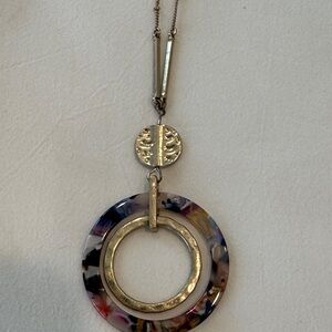 18” long pendant necklace.  Gold toned with multi colored circle.